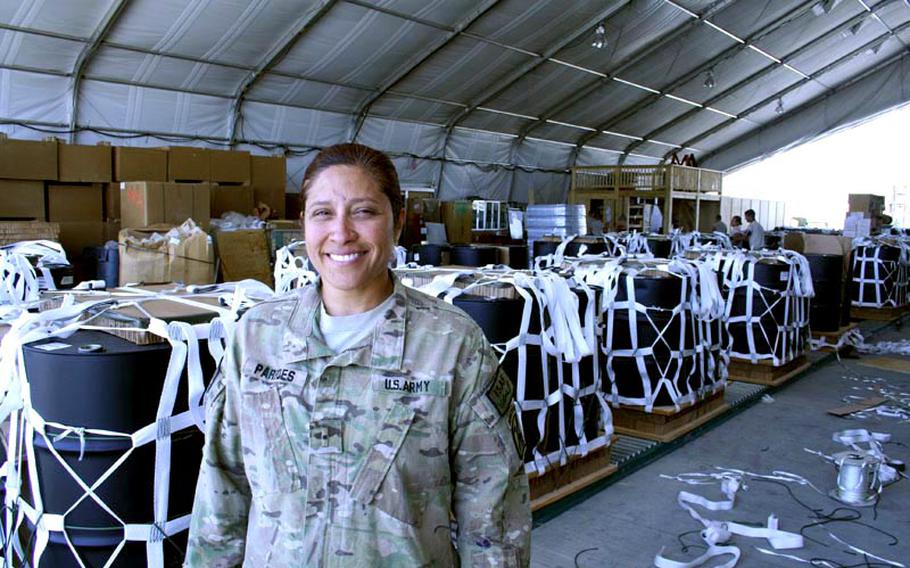 Army Warrant Officer Viviana Paredes, an airdrop systems technician who oversees the rigging of bundles for airdrops at Bagram Air Field, Afghanistan, sometimes travels to small Army bases to watch the bundles float to earth and make sure cargo reaches the ground safely.