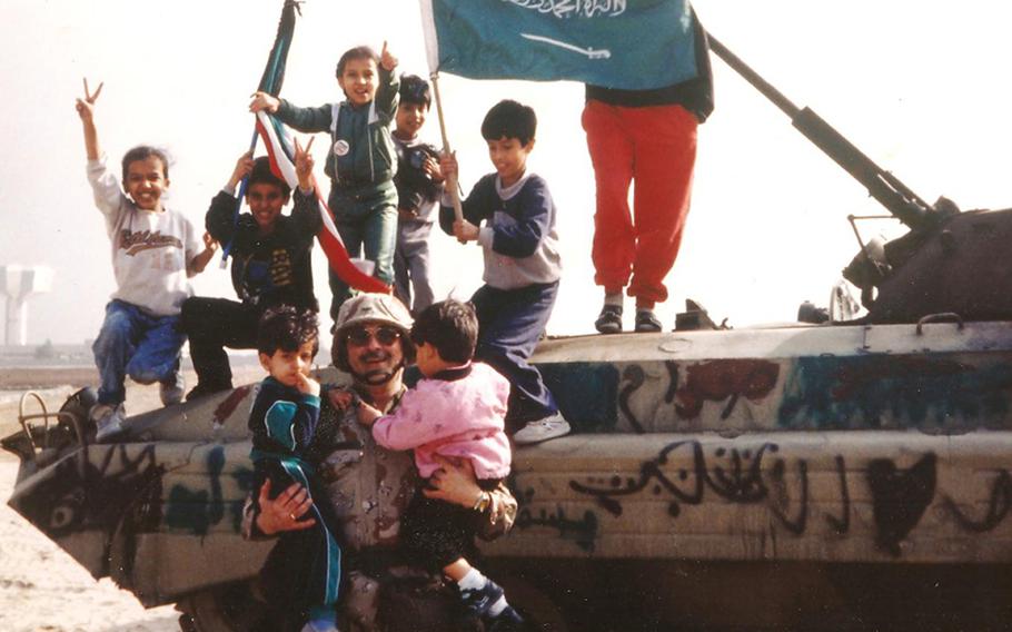 Robert D. Burgener, then a warrant officer candidate, is shown in this photo from Kuwait in 1991. Burgener encouraged a group of local parents to snap one souvenir photo of a captured Iraqi vehicle on the condition they would then leave. Moments before, with their kids climbing all over the Soviet designed armored personnel carrier, an explosive ordnance disposal specialist warned Burgener there was a live hand-grenade booby-trapped inside. The EOD folks had no luck in ordering the kids to leave.  Burgener applied his powers of persuasion and got them out of harm?s way.