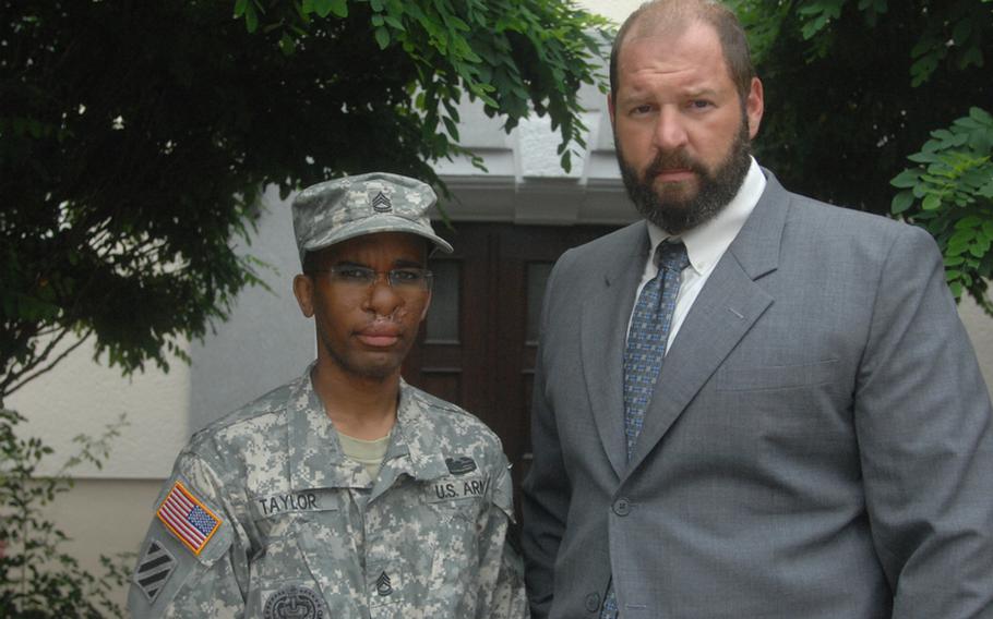 Sgt. 1st Class Walter Taylor stands with his attorney, James Culp, outside the law center in Bamberg, Germany.