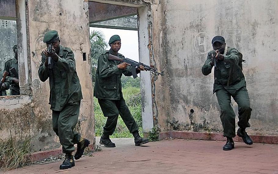 Congolese soldiers perform room-clearing exercises in the former Belgian army officer quarters in this April 2011 photo taken in the military camp in Kisangani, Democratic Republic of the Congo. A U.S.-trained light infantry battalion of Congolese soldiers has been redeployed to help halt advances by the M23 rebel group in the DRC, according to the United Nations.