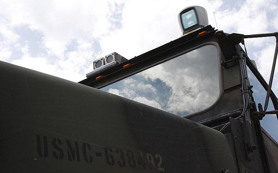 Cameras and a laser sensor are seen atop an unmanned Cargo UGV truck that is part of a larger convoy that also includes human-driven vehicles in a test of robotic systems at Fort Pickett, Va., on July 30, 2012.