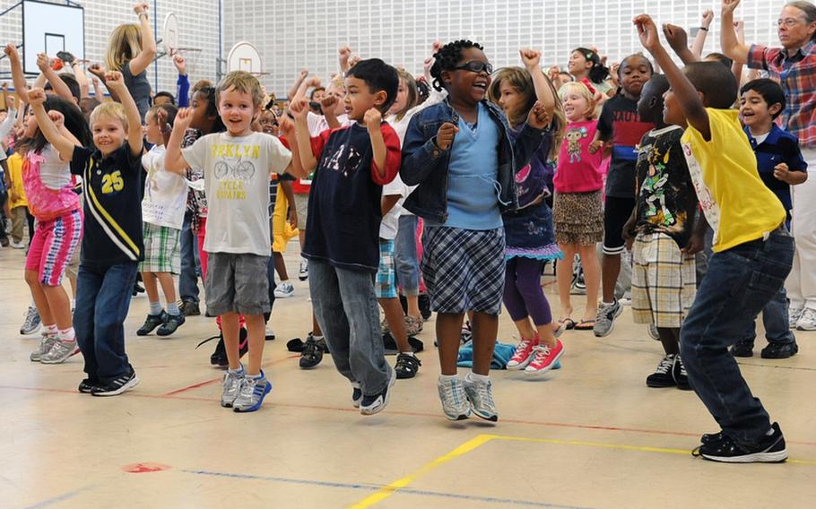 Patrick Henry Elementary School students get their morning exercise with Sue Hertling, wife of U.S. Army Europe commander Lt. Gen. Mark Hertling. The Hertlings were at the Heidelberg, Germany, school to kick off "Fueling the Future", a health and nutrition initiative.