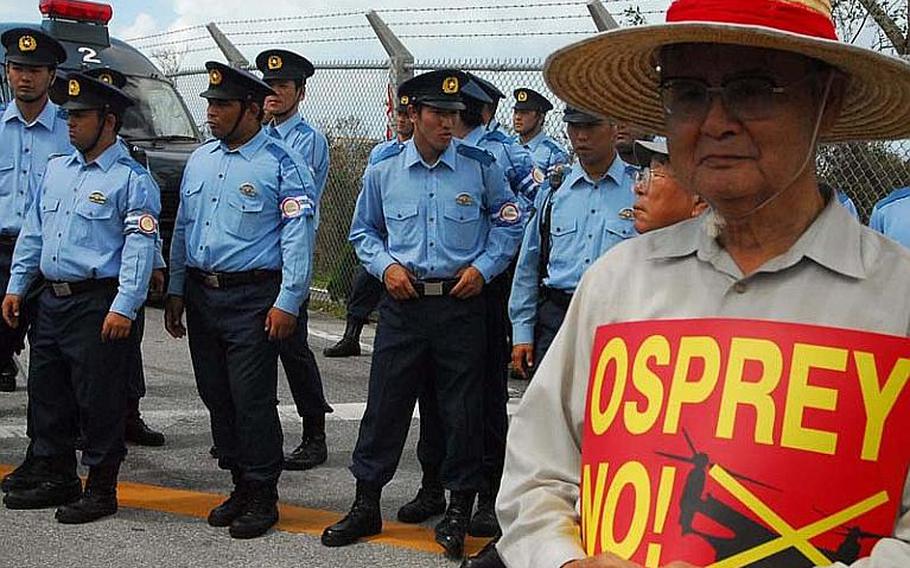 Japanese police keep protesters away from a Marine Corps security checkpoint at Futenma air station Oct. 1, 2012, as controversial MV-22 Osprey aircraft arrived at the base for a permanent deployment.