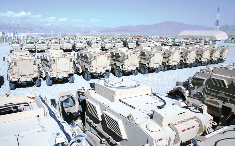 Acres of Mine-Resistant Ambush-Protected vehicles no longer needed in Afghanistan await airlift out of the country in June.