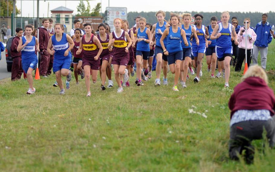 Runners from the Vilseck, Hohenfels, Bamberg, Munich International and Ansbach girls cross country teams begin a run at Ansbach on Saturday.