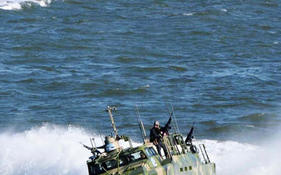 Sailors assigned to Riverine Group 1 stand their post aboard command boats as they conduct turning maneuvers at Naval Station Norfolk on Oct. 22, 2010. 