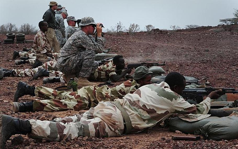 U.S. soldiers train Djibouti Armed Forces soldiers in marksmanship skills during an exercise at Camp Ali Ouney, Djibouti, in February 2011.