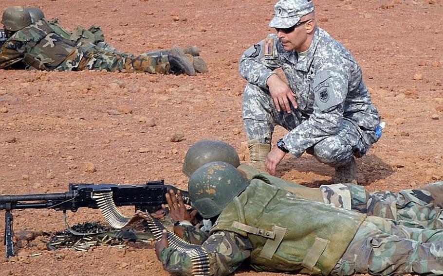 Army 1st Lt. Salvatore Buzzurro works with members of the Republic of Sierra Leone armed forces in August 2011 on basic soldiering skills in preparation for the African Union Mission in Somalia.