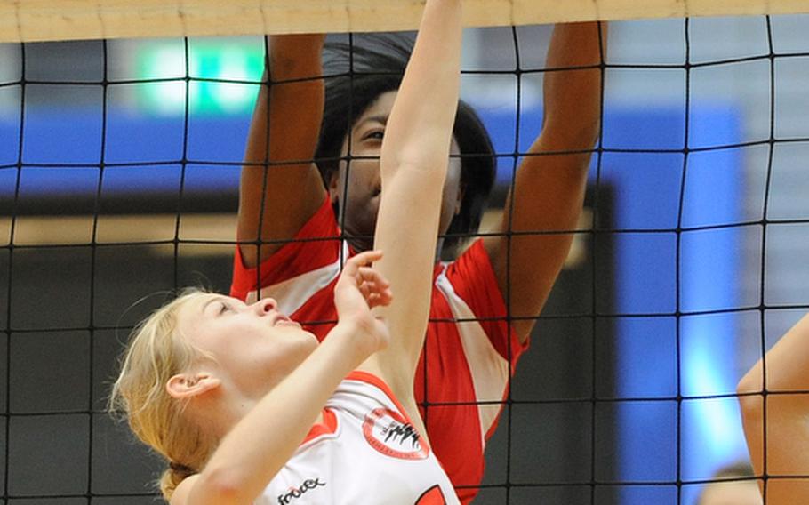 AOSR's Olivia Mansager, foreground, tries to get the ball past Schweinfurt's  Shadaja Gamble in a Division II match at the DODDS-Europe volleyball championships. The Falcons beat Schweinfurt 25-22, 30-28.
