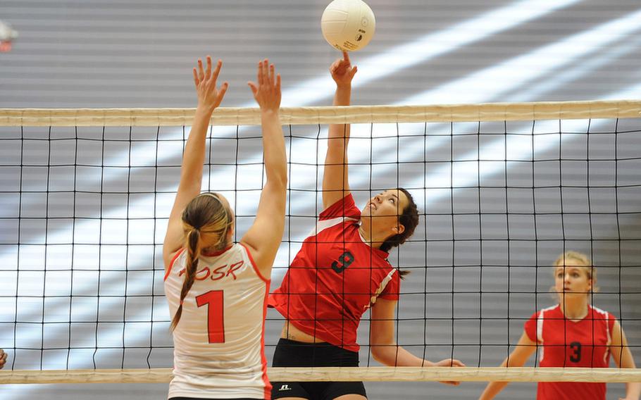Schweinfurt's Tricia Valverde tips the ball over the net against AOSR's Ceara Lafferty in a Division II match at the DODDS-Europe volleyball championships. The Falcons beat Schweinfurt 25-22, 30-28.