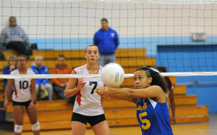 Sigonella's Deeanna Brown returns a Menwith Hill shot as the Mustangs' Kaia Pierce waits at the net. Sigonella won the Division III match at the DODDS-Europe volleyball championships 25-16, 25-19.