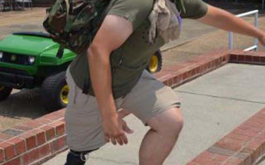 Retired Marine William Gadsby climbs a wall carrying a heavy pack, showing off his X2 microprocessor knee from Ottobock and BiOM ankle.