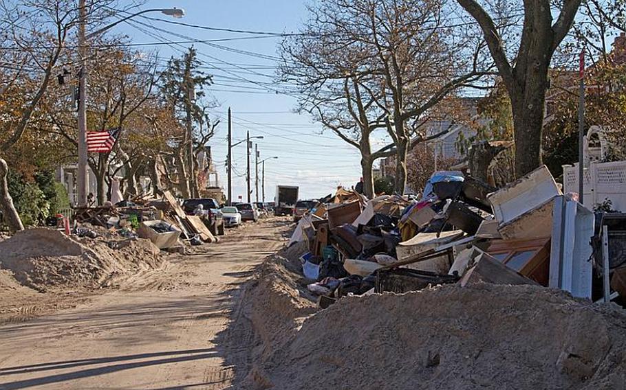 Sand, debris and junked household goods line the streets of neighborhoods in the Rockaways in New York on Nov. 4.