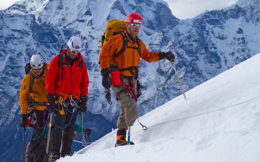 Chad Butrick, Ike Isaacson, Matt Murray, right to left, three-fourths of the the way up Lobuche Peak in Nepal at about 18,000 feet. The 2010 expedition by a group of wounded vets launched a new program, Soldiers to Summits, which aims to empower vets who suffered severe injuries, such as amputations.