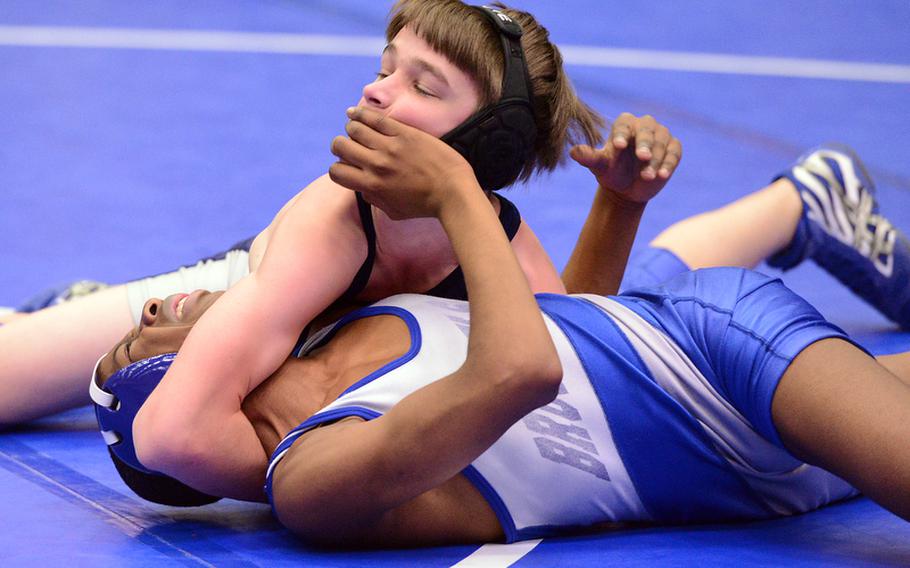 Bitburg's Brandon Beaumont, top, puts on the pressure despite the efforts of Mohamed Toure of Brussels to keep him away. Beaumont won the 113-pound match in Ramstein, Saturday.