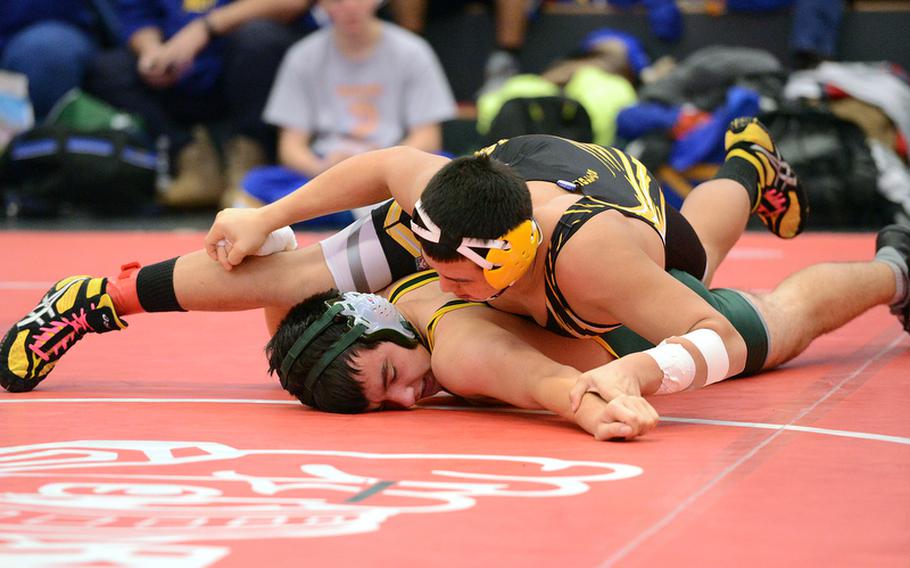Patch&#39;s Caine Collins, top,presses Alconbury&#39;s Chris Dufresne to the mat in their 170-pound match in Kaiserslautern on Saturday.