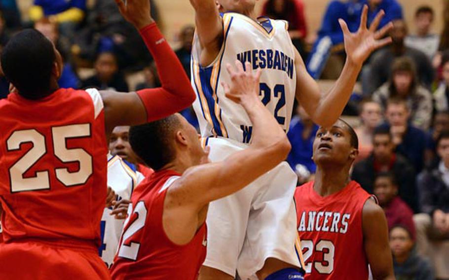 Wiesbaden's Kelsey Thomas gets between Lakenheath's Andre Bowser, left, and AJ Ransom for a shot in Saturday's game in Wiesbaden. The Lancers beat Wiesbaden 50-47. At far left is Albert Jones.