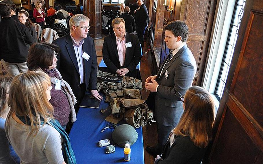 Zachary Zimmerman, a Georgetown junior and Marine Corps veteran, shows off body armor and other military equipment to university faculty members during the school's Vet Ally event on Feb. 15.