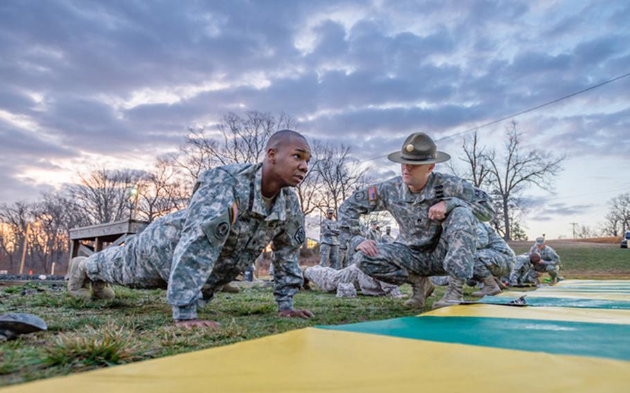 Staff Sgt. Adam Zimmerman observes Spc. Tony Brown, 3rd Chemical Brigade, as he completes pushups during day two of the 2013 Best Warrior Competition, being held April 1-5, 2013, at Fort Leonard Wood, Mo. Brown is competing to be the installation's next Soldier of the Year.