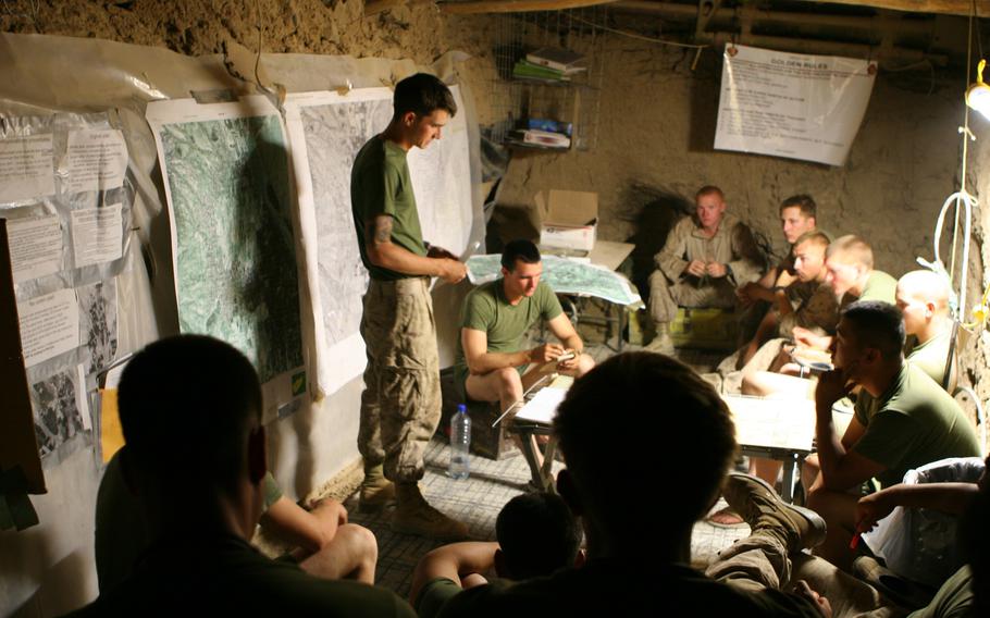 U.S. Marines with 2nd Battalion, 3rd Marine Regiment, Company G are briefed by Sgt. Derek Forte the night before a patrol.