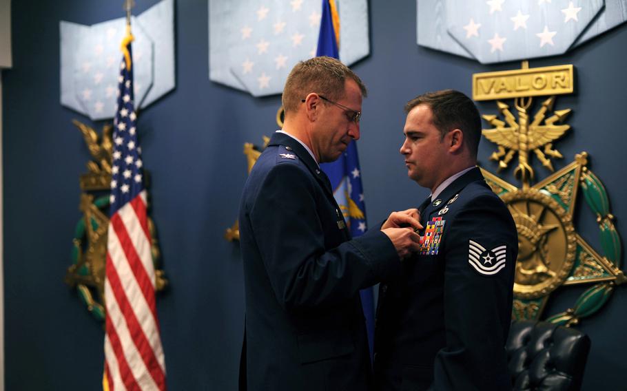 Col. Jim Slife, commander 1st Special Operations Wing, pins a Silver Star on Air Force Tech. Sgt. Joseph Deslauriers, an explosive ordnance disposal technician from the 1st Special Operations Civil Engineer Squadron, during a ceremony at the Pentagon, Nov. 14, 2012. Deslauriers earned the medal for gallantry in action while serving in Afghanistan.