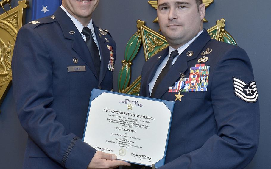 Col. James Slife, Commander, 1st Special Operations Wing, presents the citation to accompany the Silver Star to Tech Sgt. Joseph Deslauriers during a ceremony at the Pentagon on November 14, 2012.