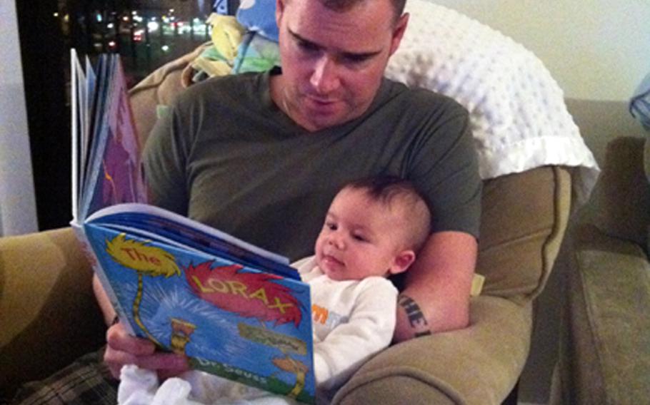Silver Star recipient Joe Deslauriers reads to his son Cameron.