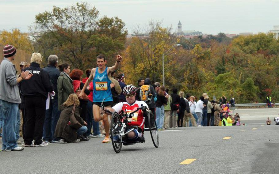 Joe Deslauriers, seated, a Silver Star recipient, pushes on during the final 1/4 mile of Marine Corps Marathon in Washington, D.C., in October 2012.