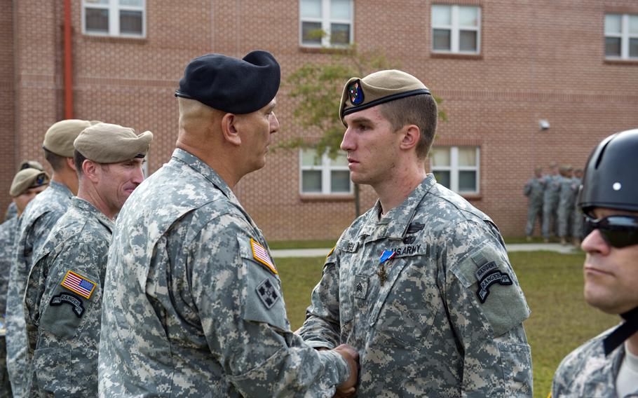U.S. Army Chief of Staff Gen. Ray Odierno presents the Distinguished Service Cross to Sgt. Craig Warfle, from Charlie Company, 1st Battalion, 75th Ranger Regiment, during an award ceremony at Hunter Army Air field, Ga., Oct. 26, 2012. Warfle received the award for his actions during combat operations in Afghanistan.