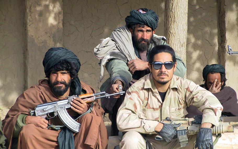 Sgt. 1st-Class Gil Magallanes, part of the first special-forces team sent into southern Afghanistan, with some Afghan fighters in November, 2001.