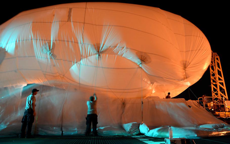 Contract mariners assigned to the Military Sealift Command high speed vessel Swift and the Raven Aerostar team inflate a tethered TIF-25K aerostat in Key West, Florida on April 22, 2013.