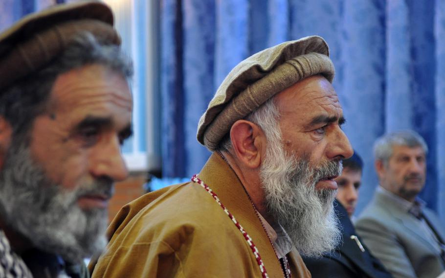 Mohammad Ali, foreground, and Abdul Malik Hamwar recall memories of their days fighting Soviet troops during the 1980s. The pair joined hundreds of other former mujahideen, as well as younger admirers at an event commemorating the Soviet withdrawal.