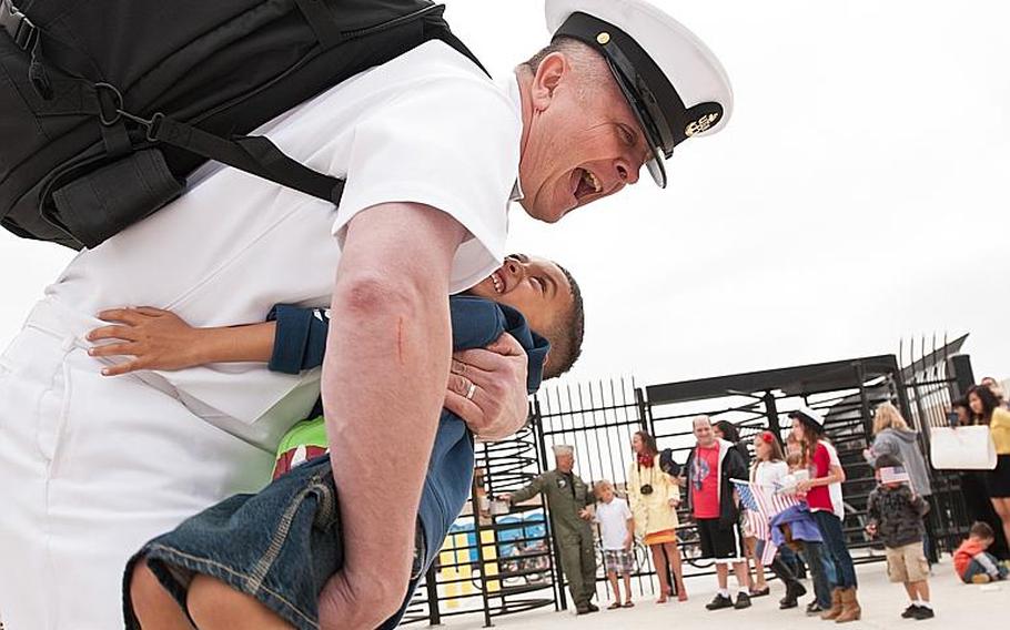 A Sailor assigned to the aircraft carrier USS John C. Stennis (CVN 74) embraces his son after arriving at Naval Air Station North Island April 29th, 2013. The John C. Stennis Carrier Strike Group returned from an eight-month deployment to the U.S. 5th and 7th Fleet areas of responsibility.