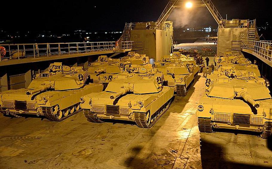 M1A1 Abrams tanks are staged for off-load on the deck of Army Logistics Support Vessel 4 off the shore of Pohang, Republic of Korea.