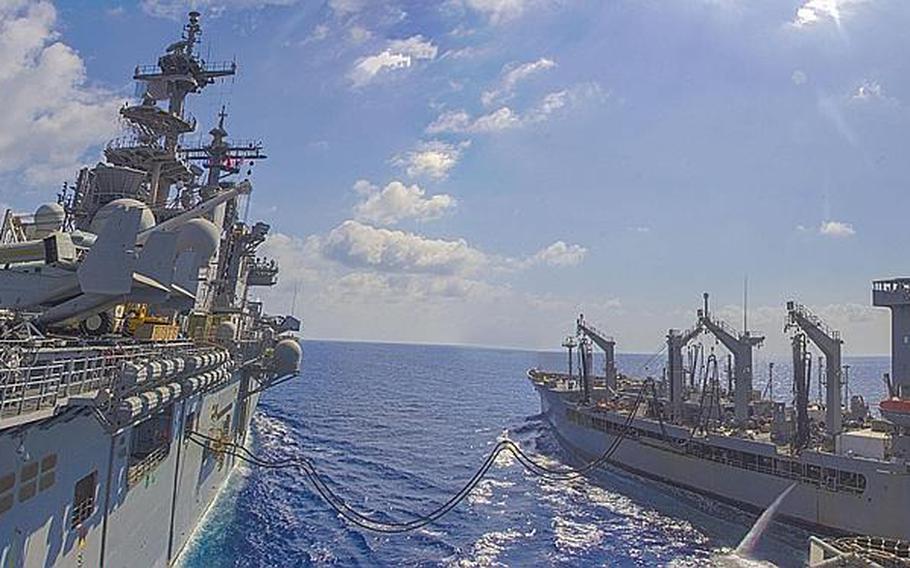 The USS Kearsarge and the USNS Walter S. Diehl sail parallel with each other in order to conduct a resupply at sea while underway, May 02, 2013.