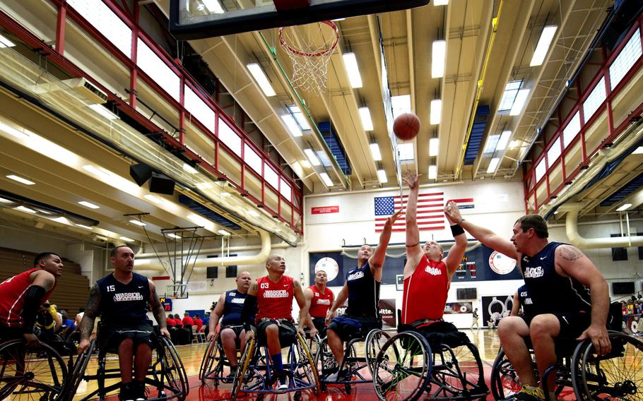 Marine and Navy wheelchair basketball players fight for a rebound during the first round of the wheelchair basketball tournament at the 2013 Warrior Games at Colorado Spring, Colorado, on May 14, 2013.