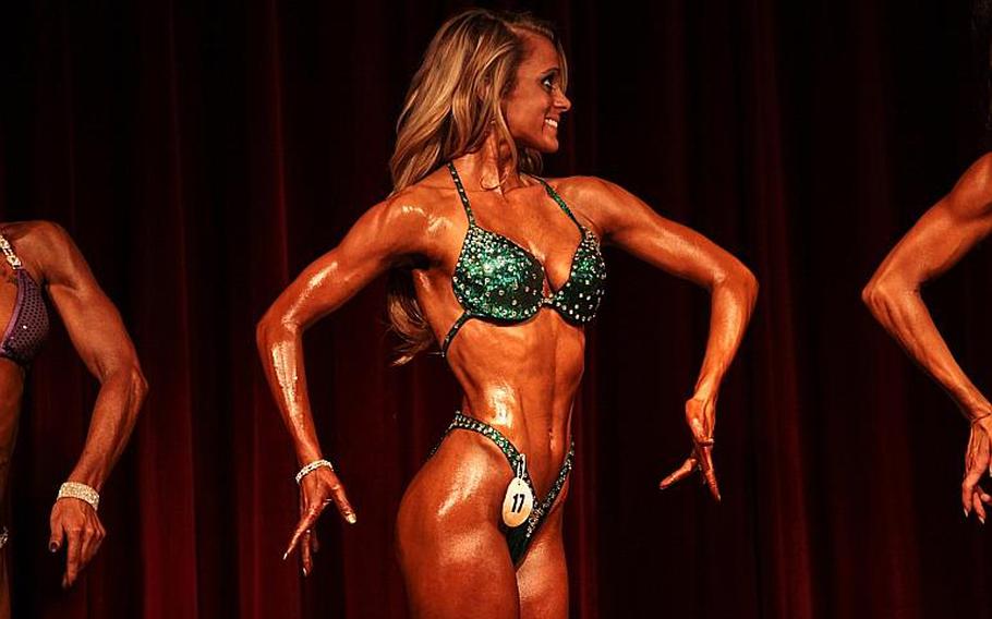 Sandra Powell, an Army spouse, poses for judges Saturday in the 2013 Bodybuilding and Figure Invitational in Kaiserslautern.