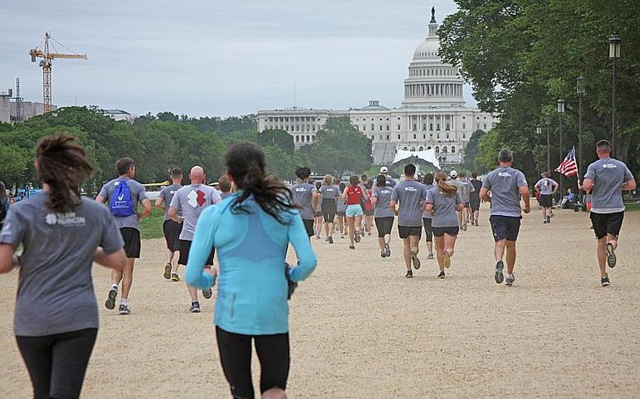 Members of Team RWB and Team Rubicon run along the National Mall in during the "Run as One" event in Washington, D.C., on May 18.