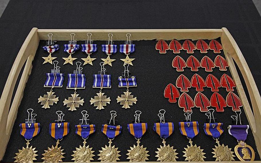Awards and coins are arranged in anticipation of a ceremony for members of the 160th Special Operations Aviation Regiment (Airborne).