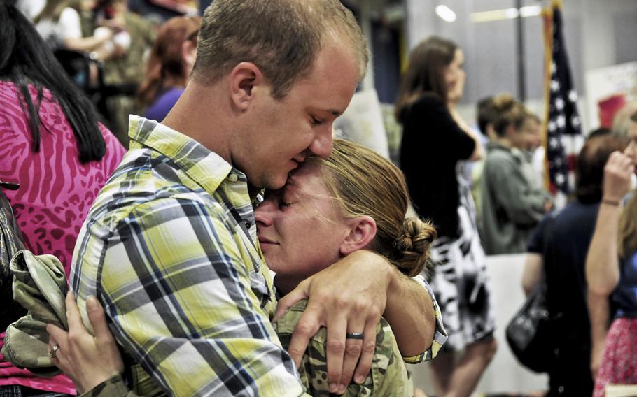Spc. Jessie Nelson, 4th Brigade, 2nd Infantry Division (Stryker), hugs her husband, Matt, at Soldiers Field House on Joint Base Lewis-McChord, Wash. Nelson and approximately 230 other soldiers returned home after an eight-month deployment to Afghanistan.