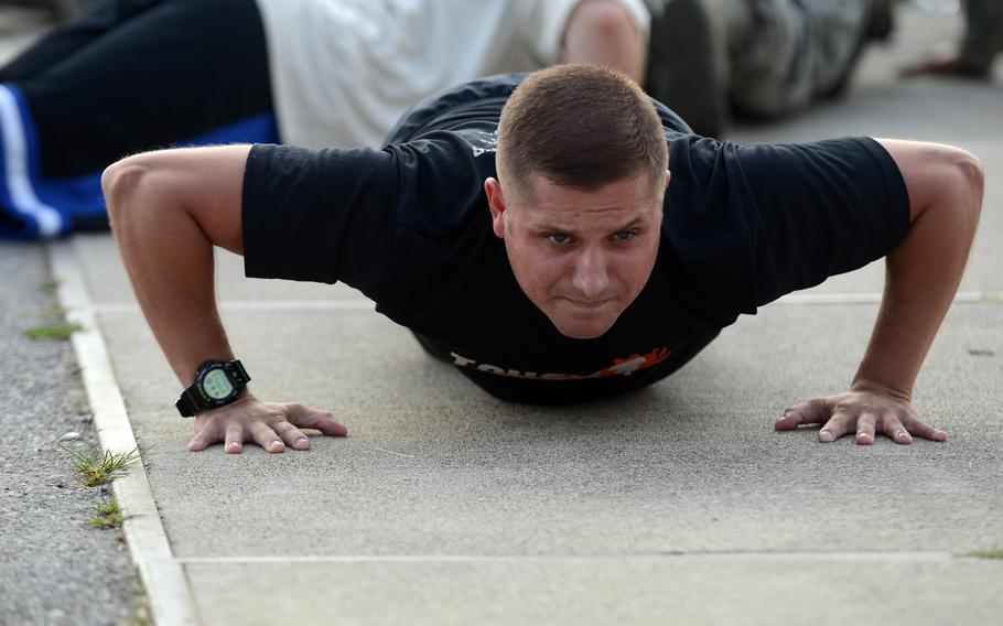 A participant in the 3rd annual Sgt. Del Toro Combat Run sponsored by the 8th Air Support Operations Squadron finishes his 20th push-up before the start of the run July 19, 2013 at Aviano Air Base, Italy.