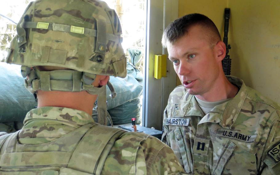 During a visit to Combat Outpost Baraki Barak in eastern Afghanistan, Capt. Travis Hairston, right, consoles a soldier whose wife in America had recently admitted to having an affair.