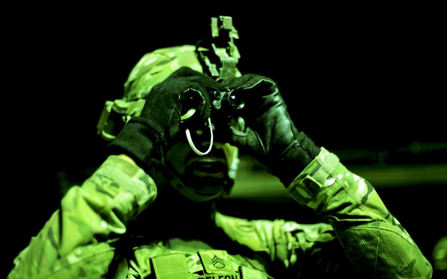 As seen through a night-vision device, U.S. Army Staff Sgt. Mark Deleon checks his personal optic device during marksmanship training on Firebase Maholic, Bagram Air Field, Afghanistan.
