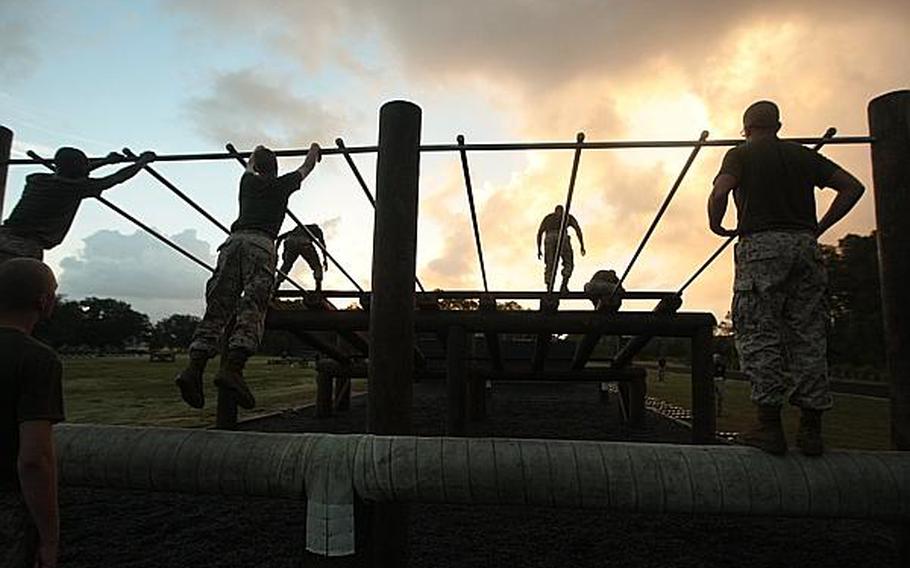 Recruits of Company I, 3rd Recruit Training Battalion, swing across parallel bars on an obstacle course Aug. 19, 2013, on Parris Island, S.C.