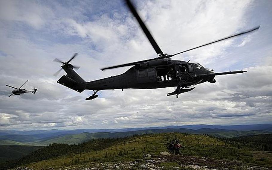 Two U.S. Air Force HH-60 Black Hawk helicopters from the 210th Rescue Squadron, Eielson Air Force Base, Alaska, arrive to rescue a simulated downed pilot during RED FLAG-Alaska 13-3, Aug. 22, 2013. A-10 Thunderbolts from the 163rd Fighter Squadron, Indiana Air National Guard, Fort Wayne, Ind., located the pilot and protected the area while pararescuemen performed the rescue.