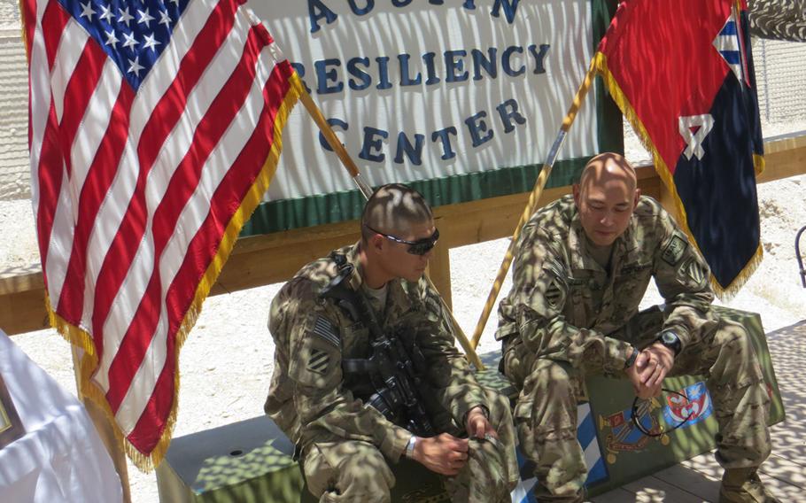 Capt. Philip Song, left, and Col. Kimo Gallahue with the 4th Brigade Combat Team, 3rd Infantry Division talk after the dedication of the Austin Resiliency Center at Forward Operating Base Shank in eastern Afghanistan. The center is named for Pfc. Barrett Austin, who died in April from injuries he suffered when a roadside bomb exploded beneath the armored truck he was driving.