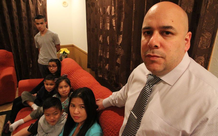 Retired Marine Chris Garcia, seen here with his wife, Natalie, and their 5 children, was promised housing allowance when he was offered a job on Okinawa. After more than 2 years on the job, Garcia has been notified that he was given the benefit in error and that he would be responsible for refunding more than $100,000 in back rent and utilities.