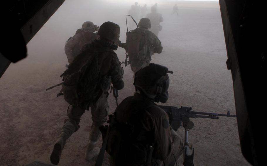 U.S. Marines and Georgian soldiers with 33rd Georgian Battalion exit an MV-22 Osprey aircraft during an operation in Helmand province, Afghanistan, on Sept. 23, 2013.