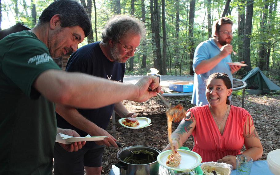 Hiker Rob Carmel, left, Blue Mountain Eagle Hiking Club President Scott Birchman, Matt Holliday of Pennsylvania Magazine  and hiker Stephanie Cutts at a cookout, one of many events hosted along the route for the Warrior Hikers.