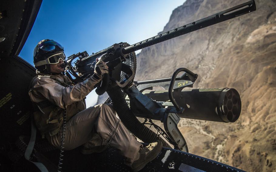 Lance Cpl. Chris Eichelberger, a Huey door gunner with a Marine Light Attack Helicopter Squadron 169, unloads on a target at the Chocolate Mountain Aerial Gunnery Range, Calif., on Oct. 2, 2013.